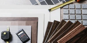 Estimating flooring installation costs with samples, a calculator, and a tape measure.
