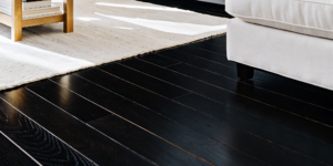 A successful engineered hardwood installation with a clean, professional finish on dark wood floors.