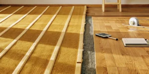 Carpet installation showing padding and subfloor, key factors in the final project cost.