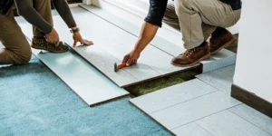 Floating LVP flooring installation with planks clicking together over underlayment.